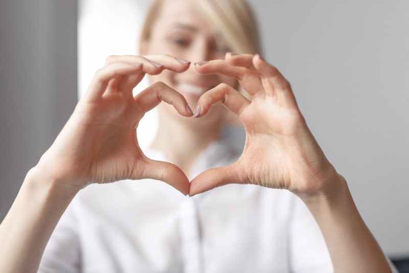 Woman holding hands as a heart shape